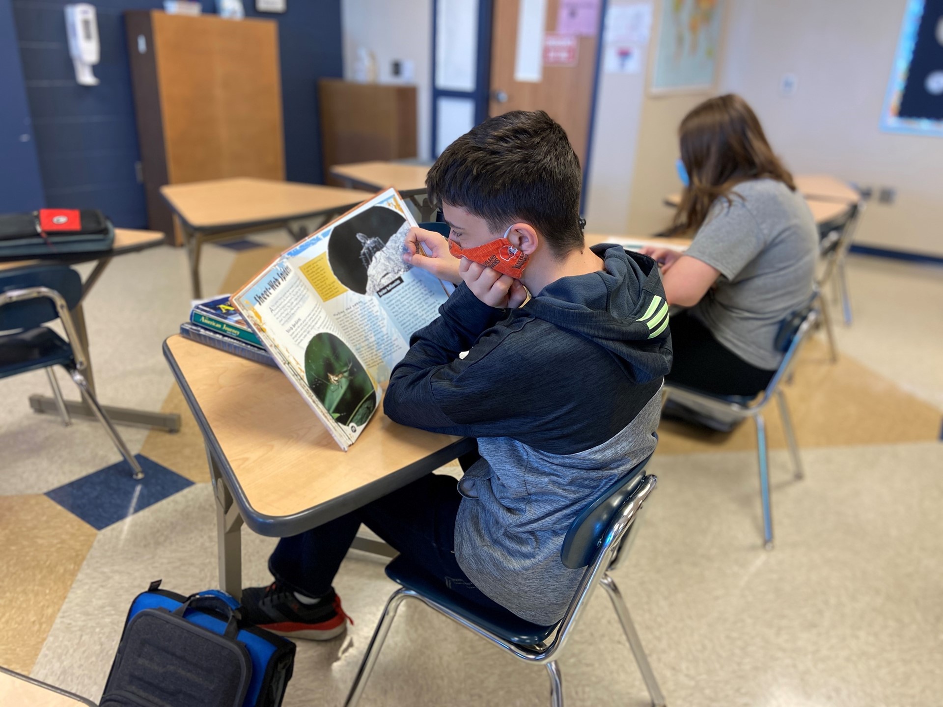 Student reads a textbook in class. 