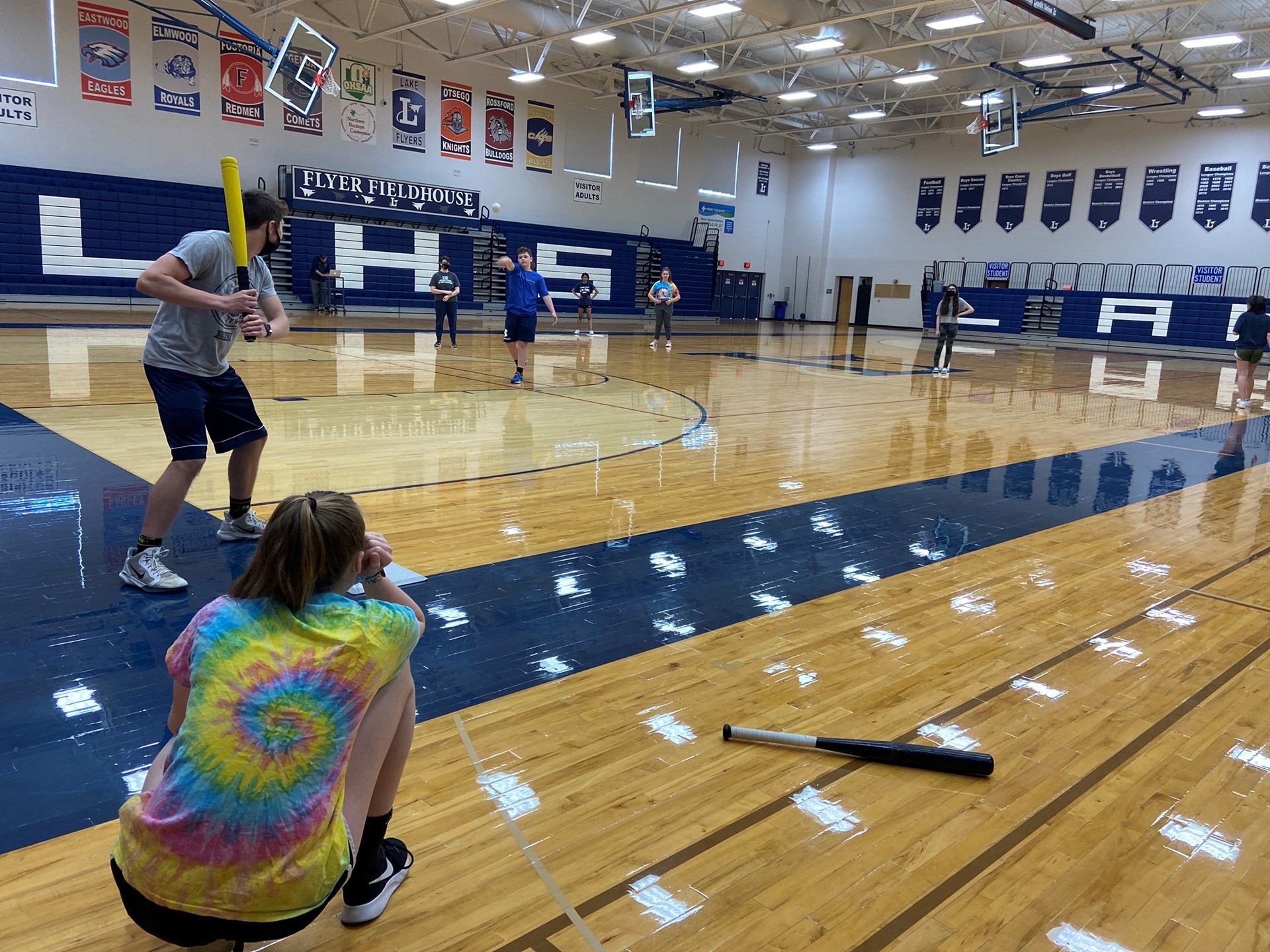 Students play baseball in Physical Education class. 