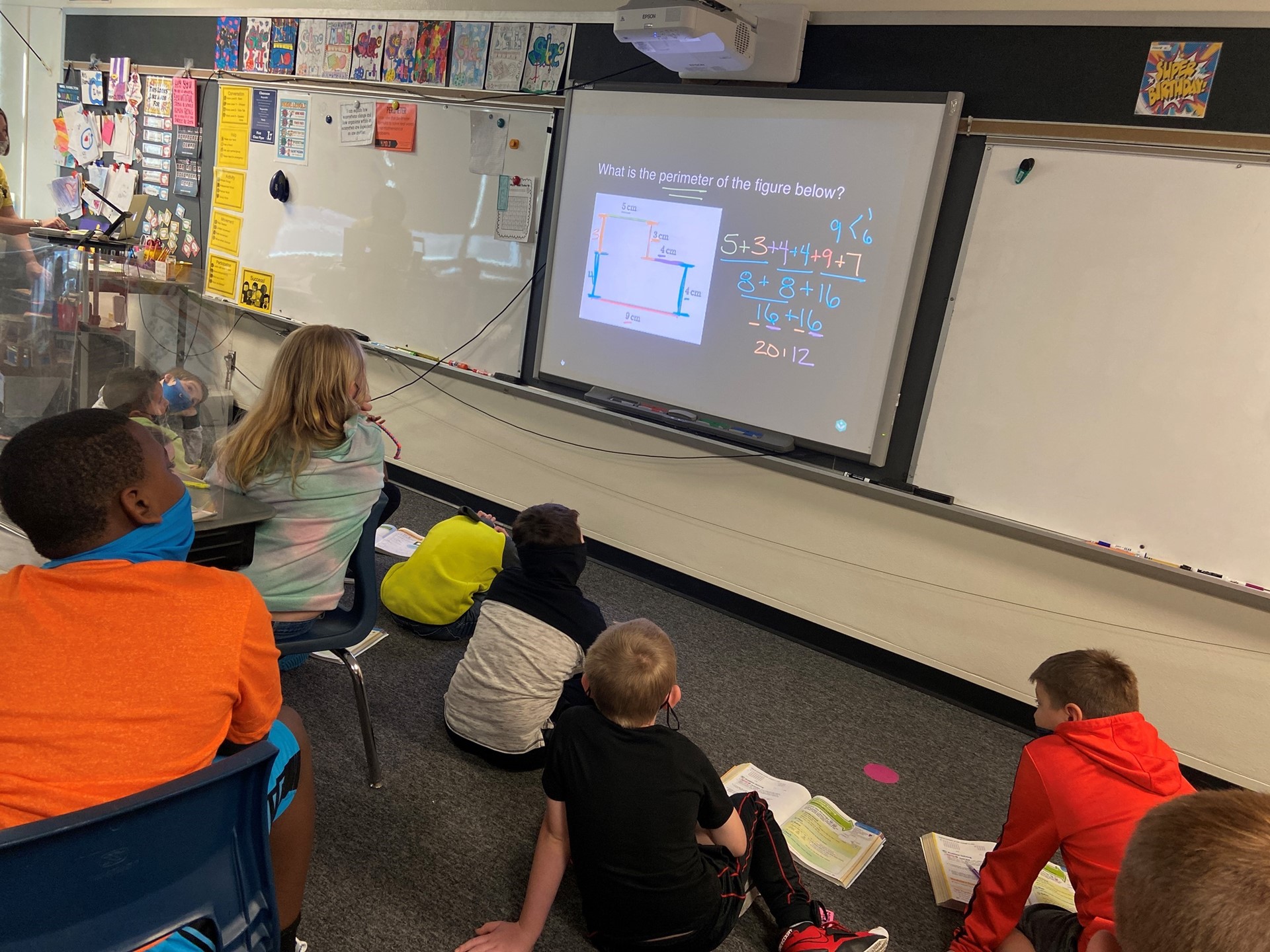 Students work as a class to find the perimeter of a figure. 