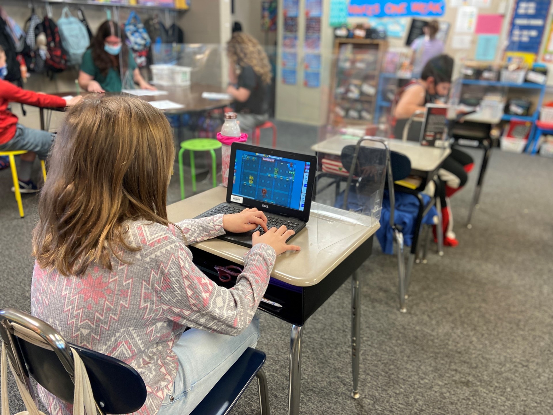 A student plays an educational game on their Chromebook. 