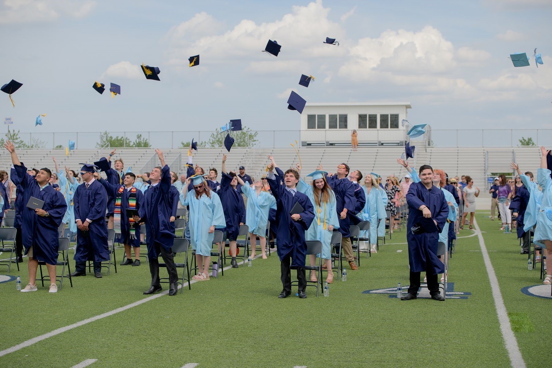 The Class of 2021 throw their graduation hats in the air at the end of the graduation ceremony. 