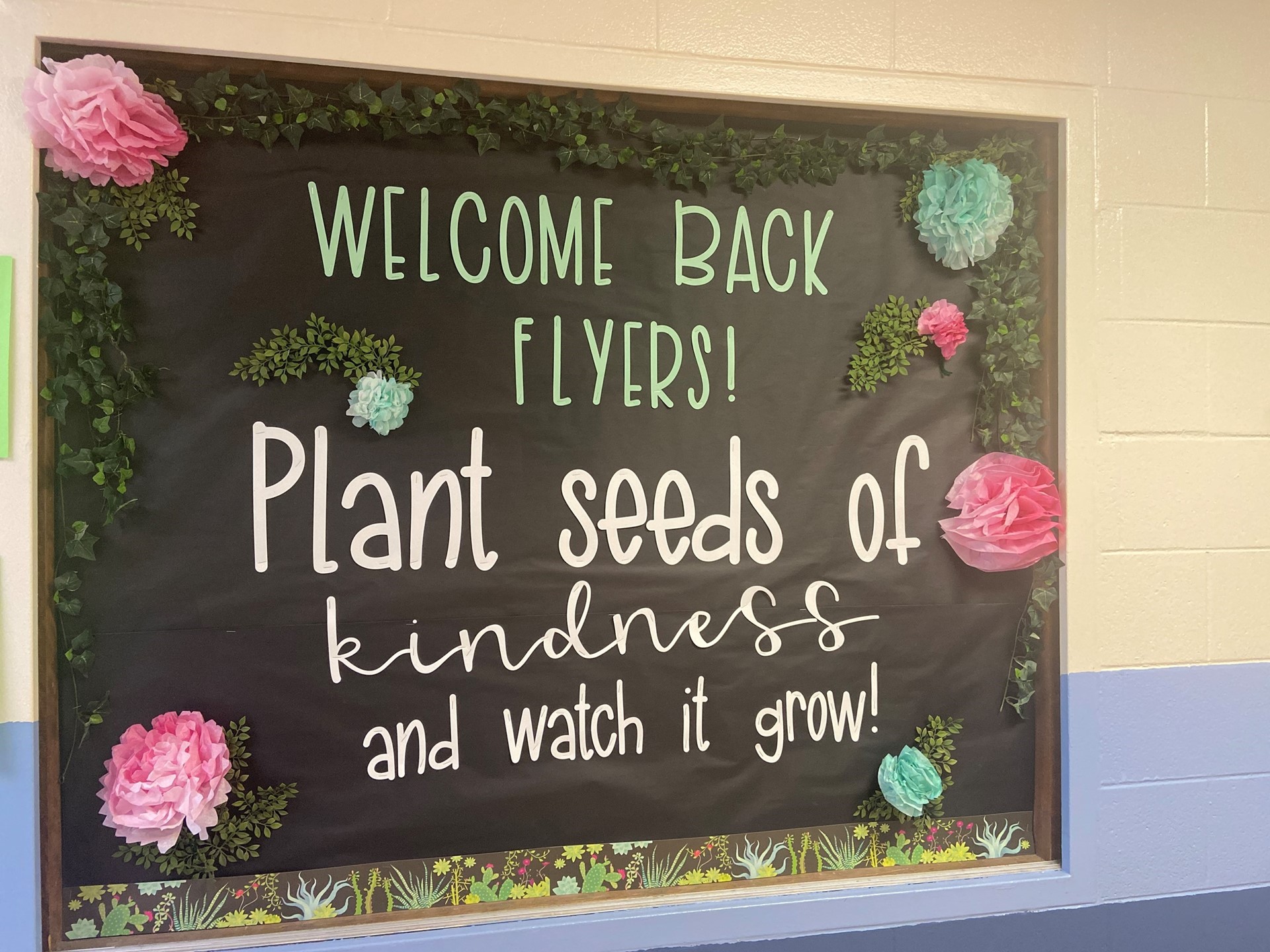 Sign reading Welcome Back Flyers! Plant seeds of kindness and watch it grow!