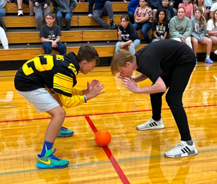Students participate in a game at a pep assembly. 