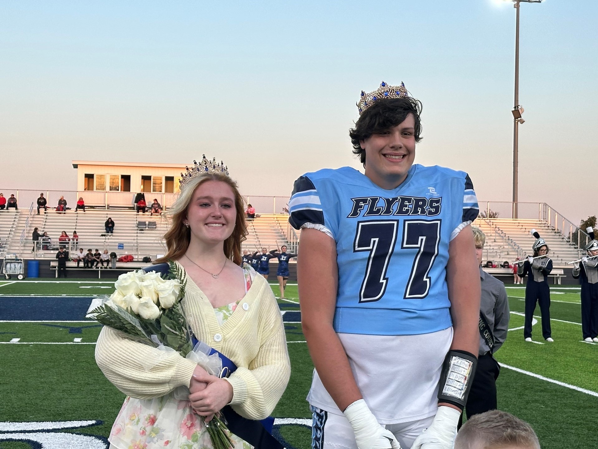 Shylo Willcutt and Cole Fisher Homecoming King and Queen on the football field at the game. 