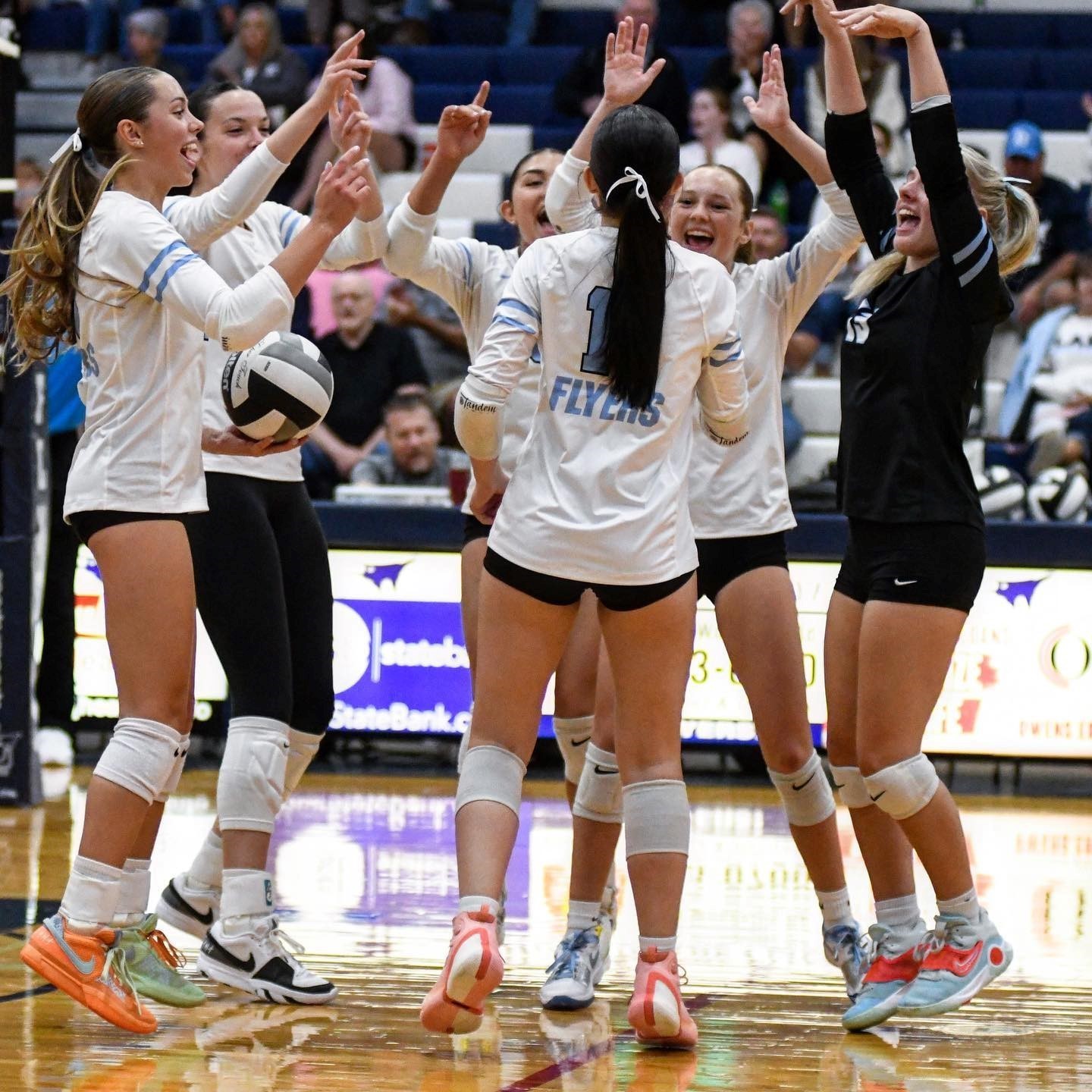 Volleyball girls celebrating a point. 