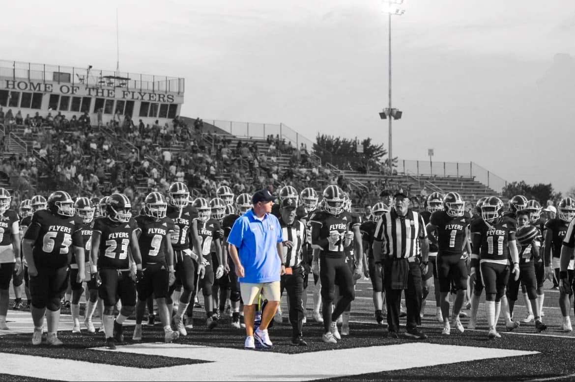 football team walking behind coach Bishop