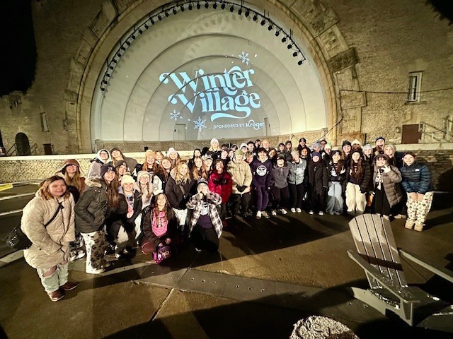 The high school choir performs at the Lights Before Christmas at the zoo. 